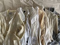 Lot of nine women's embroidered and embellished blouses in neutral and striped designs