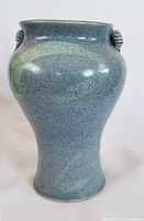 Front view of blue pottery vase showing body shape and glaze