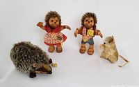 Group of four vintage Steiff toys: Mucki and Macki figurines standing, Joggi hedgehog plush laying horizontal, and small mouse plush sitting.