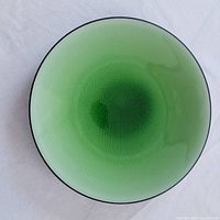 Top view showing the green crackled glazed ceramic plate with a black rim and smooth gradient color effect.