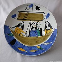 Top-down view of the bowl displaying the painted scene with people on a boat, fish below, and abstract blue shapes.