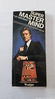 Front of box with man in suit and game image, showing 'Super Master Mind Le Cerveau'