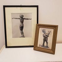 Pair of framed black and white photos depicting German sculptures, placed side by side on a white surface.