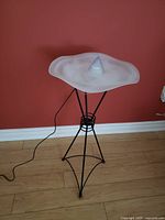 Front view of the rare Fog-Design mist-creating lamp showing the frosted glass bowl and metal stand with cord visible on floor.