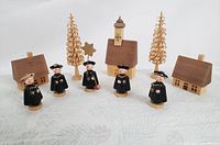 Full set of five wooden German-made vintage Christmas carollers with church, houses, and two wooden spiral trees.