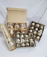 Boxed vintage silver Christmas ball ornaments and the silver glass tree topper in original storage boxes.