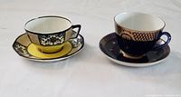 Two teacups and saucers shown side by side, highlighting design and size differences between the Russian and Wedgwood cups.