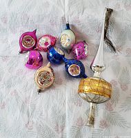 All 8 pieces of vintage Christmas tree ornaments including the 7 colorful glass ornaments and one elongated tree topper
