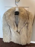 Front full view of silver tip fox fur coat showing plush collar and natural fur pattern.