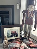 Full view of the lot items including framed horse photo, scarf, pine cone ornament, nutcracker figure, and tote bag