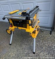 Front view of DeWalt table saw on folding stand with wheels