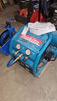 Compressor overview showing gauges, controls, handle and included paperwork