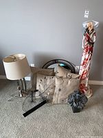 Full view of Paverpol girl statue alongside lamp, pillows, mirror, and decor items