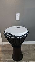 Front view of Toca djembe drum showing full drum body and drum head with rope tuning system.