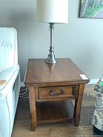 Solid wood side table with one drawer, lower shelf, and metal handle