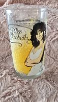 Front side of the glass showing the color illustration of Miss Elizabeth with a yellow background and her name.