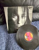Vinyl record disc with album cover sleeve showing portrait of Cher and text details