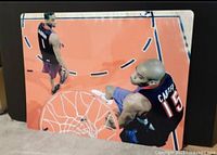 Birds-eye view image of the 2000 NBA All-Star Dunk Competition tin sign showing Vince Carter dunking and Tracy McGrady standing nearby, on a 16 by 12 inch metal sign.