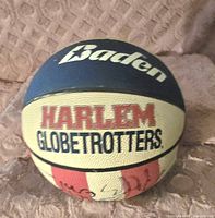 Front of basketball showing Baden brand and Harlem Globetrotters logo with some signatures.