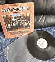 Front side of the record sleeve with group photo and vinyl record, showing album title and artwork.