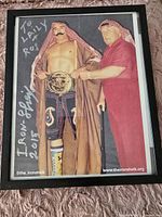 Full view of the signed framed photograph of Iron Sheik with inscription and signature