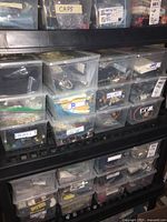 Plastic storage bins labeled for relays, capacitors (including HV caps), resistors, and other electrical components.