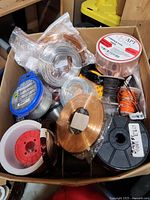 Box containing multiple rolls of copper wire, copper foil tape, and wiring.