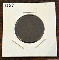 Reverse side of the 1859 Canadian large one cent coin showing the denomination and date surrounded by a decorative design.