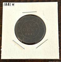Reverse side of the 1881H Canadian Large One Cent coin showing denomination "ONE CENT" and year "1881" surrounded by a wreath.