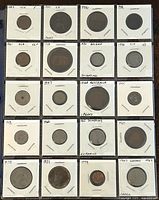 Top side of album page with 20 world coins in individual holders, dated 1883 to 1986, various countries noted