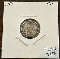 Obverse side of the 1918 Canadian 5 cents coin showing the denomination and maple leaf design.