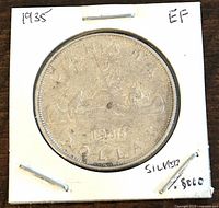 Front view of 1935 Canadian silver 1 dollar coin showing voyageur and canoe design with date 1935 and labeled EF condition and silver content.