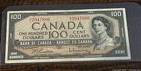 Front of the 1954 Canada $100 banknote in protective sleeve