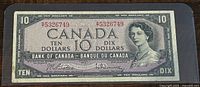 Front view of the 1954 Canada ten dollar banknote showing Queen Elizabeth II portrait, serial numbers, and bilingual text.