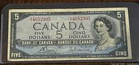 Front face of 1954 Canadian $5 banknote showing portrait of Queen Elizabeth II.