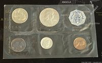 Top view of six 1960 US coins in original sealed plastic packaging showing front sides including detailed faces and date marks.