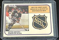Front of the 1981-2 O-Pee-Chee Wayne Gretzky Edmonton Oilers NHL assist leader trading card. Shows Wayne Gretzky in Oilers uniform, NHL logo, and bilingual assist leader text.