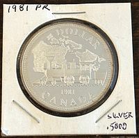 Reverse side of 1981 Canadian silver proof 1 dollar coin showing steam locomotive and inscriptions.