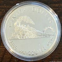 Reverse side of the coin showing the 1886 Vancouver commemorative steam locomotive design and inscriptions.