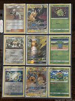 Front of 9 assorted Pokémon cards laid out in a 3x3 grid within a plastic sleeve, showing card artwork and details.