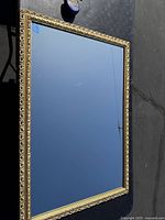 Full view of large rectangular mirror showing its reflective surface and outer frame.