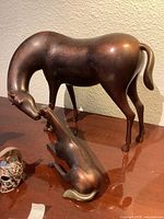 Front view of Loeto bronze adult horse and foal sculptures on tabletop