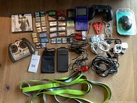 Overview of entire lot showing consoles, controllers, cartridges, pouches, cables, accessories