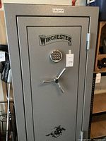 Front view of safe showing full door, Winchester logo, keypad and handle