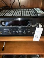 Front view of Yamaha RX-V863 AV receiver with remote on top, showing brand, model, input types including HDMI, and digital audio logos.