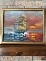 Front view of painting showing sailing ship at sea