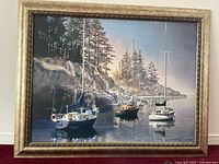 Full view of the framed painting showing sailboats on water near rocky shore and trees.