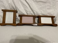 Set of 3 handcrafted wooden picture frames, different orientations, showing pegged openings and wooden base details.