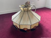 Octagonal beige and brown Tiffany style hanging lamp with stained glass panels, metal frame, and 40 inch hanging chain, viewed from side and top.