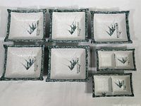 Full set of five square bowls and two smaller divided condiment dishes with bamboo motif.